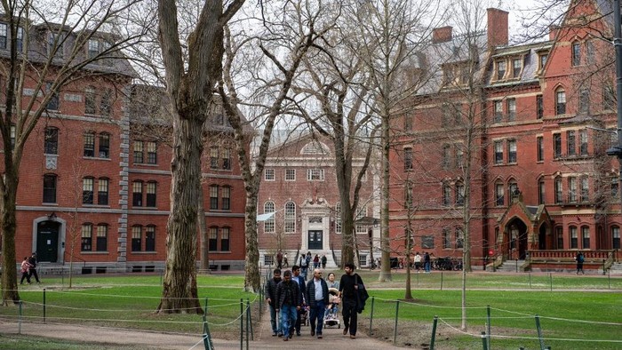 (FILES) People walk through Harvard Yard on the Harvard University campus in Cambridge, Massachusetts, on April 15, 2025. US President Donald Trumps administration on Thursday revoked Harvards right to enroll foreign students -- more than a quarter of its annual enrollment -- in a major escalation of the presidents fight with one of the worlds most storied universities. Trump is furious at Harvard -- which has produced 162 Nobel prize winners -- for rejecting his demand that it submit to oversight on admissions and hiring over his claims that it is a hotbed of anti-Semitism and 