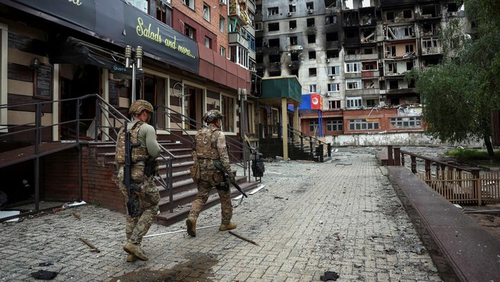 Members of the White Angel unit of Ukrainian police officers who evacuate people from the frontline towns and villages, check an area for residents, amid Russias attack on Ukraine, in the frontline town of Pokrovsk in Donetsk region, Ukraine May 21,