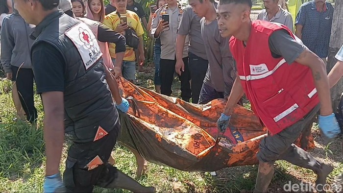 Petugas saat mengevakuasi jasad Anton yang tewaas tersetrum saat berburu belut