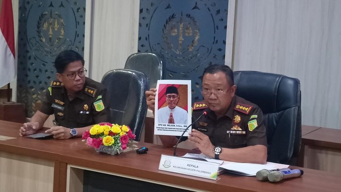 Kajari Palembang Hutamrin menunjukkan foto tersangka eks Kadis PMD Provinsi Sumsel Wilson yang DPO