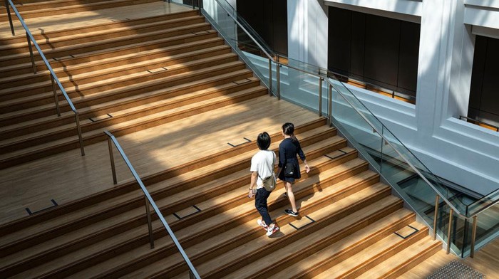 SINGAPORE, SINGAPORE - MARCH 30: People walk up a flight of stairs with safe distancing markers at the National Gallery of Singapore on March 30, 2020 in Singapore. The Singapore government has introduced several safe distancing measures to curb the spread of COVID-19. The Coronavirus (COVID-19) pandemic has spread to many countries across the world, claiming over 20,000 lives and infecting hundreds of thousands more. (Photo by Ore Huiying/Getty Images)