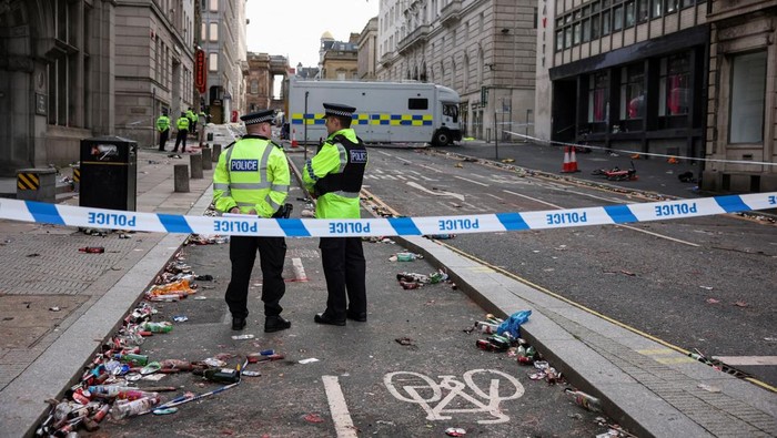 Forensic officers work near the site of an incident where a car plowed into a crowd of Liverpool fans during a parade celebrating their sides Premier League soccer title, in central Liverpool, Britain, May 27, 2025. REUTERS/Phil Noble