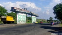Dua pilar beton berdiri kokoh di tengah jalan Porong lama. Bangunan itu dikenal warga dengan sebutan Tol Buntung atau Tol Pedot, menjadi saksi bisu dari tragedi semburan lumpur panas Lapindo yang terjadi hampir dua dekade silam.