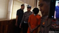 Terlihat ada borgol yang membelenggu kedua tangannya. Kepalanya pun menunduk saat muncul di hadapan wartawan.
