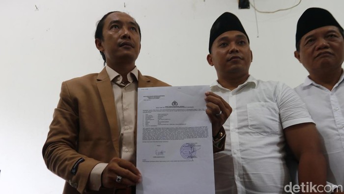 Kuasa hukum Yayasan Ponpes Ora Aji asuhan Gus Miftah, Adi Susanto (kiri) menunjukkan surat tanda laporan polisi terkait kasus pencurian yang dilakukan santri inisial KDR, di Ponpes Ora Aji, Kalasan,  Sleman, Sabtu (31/5/2025).