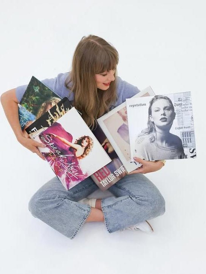 Taylor Swift berfoto dengan sampul 6 album pertamanya di label BIG MACHINE yang kini resmi jadi miliknya lagi.