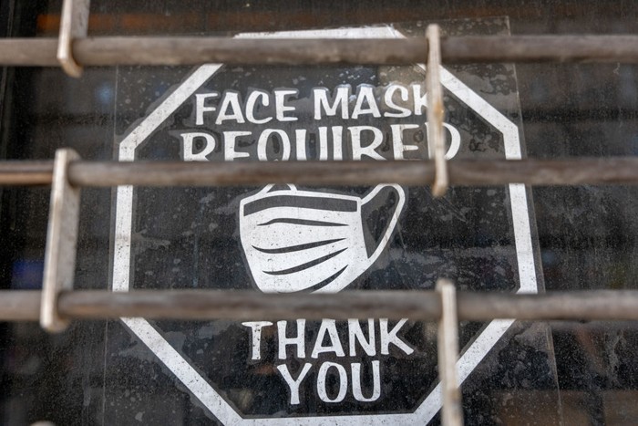 NEW YORK, NEW YORK - MARCH 11: An old sign in a window of a closed business asks customers to wear a mask to prevent the spread of COVID-19 as the nation marks the fifth anniversary of the Covid-19 pandemic on March 13, 2025 in New York City. While the pandemic is mainly contained and most Americans have returned to the office, thousands of people still contract the virus monthly. As of March 6, at least 1,222,603 Americans have died of COVID-19, according to data from the Centers for Disease Control and Prevention. (Photo by Spencer Platt/Getty Images)