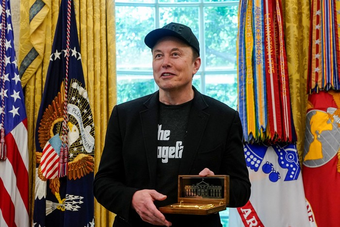 Elon Musk receives the key to the White House from U.S. President Donald Trump during a press conference in the Oval Office at the White House, in Washington, D.C., U.S., May 30, 2025. REUTERS/Nathan Howard