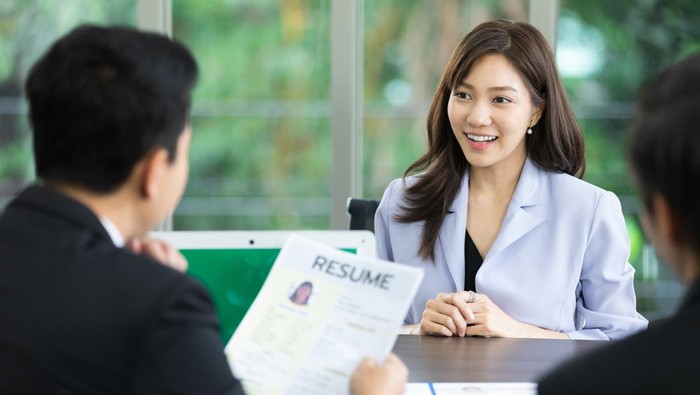hr officer holding resume at job interview, considering woman employee candidature for open work position