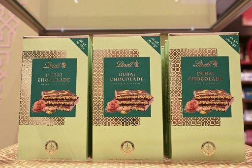 GERMANY-BUSINESS-LIFESTYLE-DUBAI-CHOCOLATE Dubai Chocolate bars stand in a branch of chocolate producer Lindt before the sale of 100 Dubai Chocolate bars starts in Stuttgart, southern Germany, on November 15, 2024. The hype around the chocolate bar - usually filled with pistachio and tahini paste and crispy Kadaif noodles - has also sparked the interest in German customers and led to long queues outside shops. (Photo by THOMAS KIENZLE / AFP)