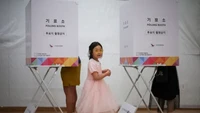 Ada pula pasangan muda yang ikut pilpres. Mereka bahkan turut membawa serta putri mereka. (Kim Hong-Ji/Reuters)