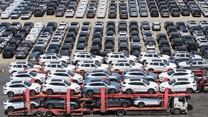 SHANGHAI, CHINA - APRIL 17: Aerial view of trucks loaded with new energy vehicles for export at a terminal of Shanghai port on April 17, 2025 in Shanghai, China. (Photo by Long Wei/VCG via Getty Images)
