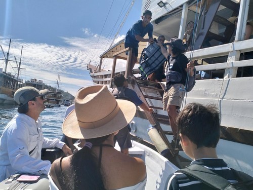 Wisatawan korban penipuan travel agent di Labuan Bajo turun dari pinisi seusai menyelesaikan trip di kawasan TN Komodo, Manggarai Barat, Rabu (4/6/2025). (Ambrosius Ardin/detikBali)