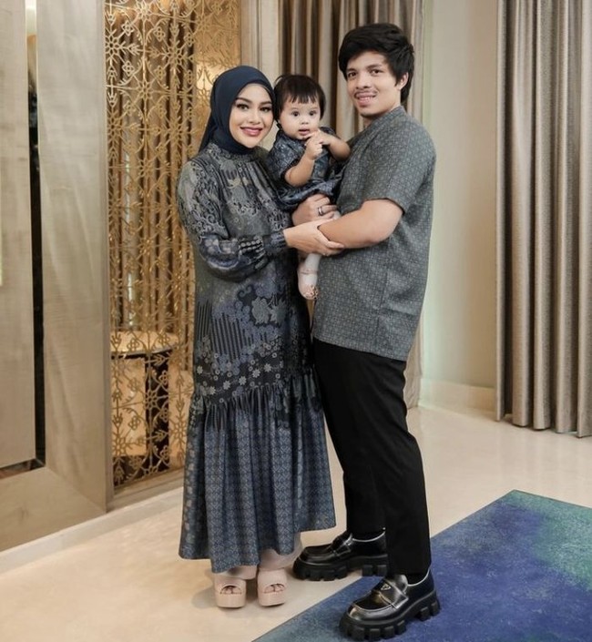 Dalam acara keluarga, Aurel tampil serasi dengan suami dan anak-anaknya mengenakan gamis motif floral warna navy, menciptakan kesan harmonis dan elegan. Gamis dengan motif yang tidak terlalu mencolok, cocok untuk generasi muda. Foto: Dok. Instagram @aurelie.hermansyah.