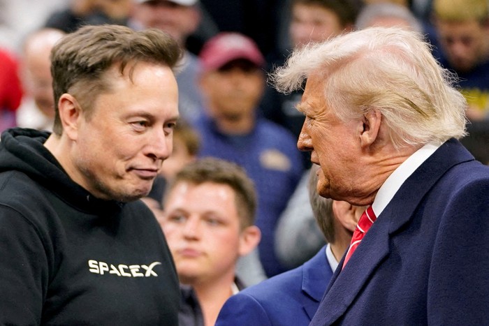 FILE PHOTO: Elon Musk greets U.S. President Donald Trump as they attend the NCAA mens wrestling championships in Philadelphia, Pennsylvania, U.S., March 22, 2025. REUTERS/Nathan Howard/File Photo