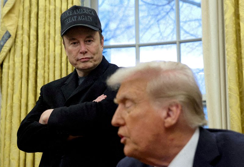 FILE PHOTO: Elon Musk listens to U.S. President Donald Trump speak in the Oval Office of the White House in Washington, D.C., U.S., February 11, 2025.   REUTERS/Kevin Lamarque/File Photo/File Photo
