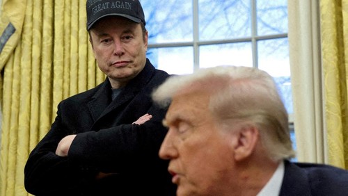 FILE PHOTO: Elon Musk listens to U.S. President Donald Trump speak in the Oval Office of the White House in Washington, D.C., U.S., February 11, 2025.   REUTERS/Kevin Lamarque/File Photo/File Photo