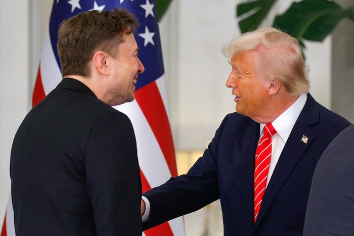 U.S. President Donald Trump speaks with Tesla CEO Elon Musk ahead of a state dinner hosted by Qatars Emir Tamim bin Hamad Al Thani, at Lusail Palace in Lusail, Qatar, May 14, 2025. REUTERS/Brian Snyder