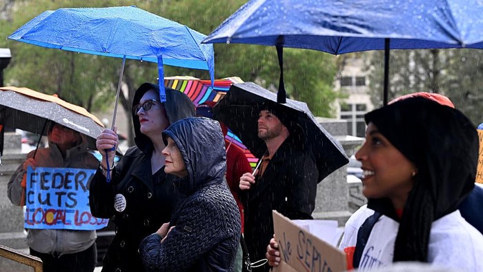DENVER, CO - MAY 6: A few dozen people braved the cold temperatures and driving rain to take part in a Coloradans Against Federal Cuts rally on the west steps of the Colorado State Capitol in Denver, Colorado on May 6, 2025. The rally brought together former federal workers, community leaders, public servants, students, concerned citizens, and candidates for federal senate and representative offices. Attendees and speakers hoped to urge the Colorado legislature to consider plans for proactive support for those impacted by current and pending federal cuts and layoffs. Testimonies from affected federal workers, academics, and small business owners spotlighted the far-reaching consequences already cascading across our state. (Photo by Helen H. Richardson/MediaNews Group/The Denver Post via Getty Images)