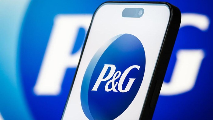 CHONGQING, CHINA - APRIL 20: In this photo illustration, the logo of Procter & Gamble Co. (P&G) is displayed on a smartphone screen, with the company's stock market performance and candlestick chart visible in the background, highlighting P&G's role as a global leader in consumer goods, offering branded products in segments including beauty, grooming, health care, fabric care, and home care, on April 20, 2025, in Chongqing, China. (Photo illustration by Cheng Xin/Getty Images)
