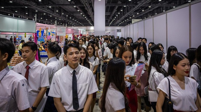  Job applicants play a game to win free prizes at the Bangkok Job Expo on June 06, 2025 in Bangkok, Thailand. Job Expo Thailand 2025, Thailand's largest career fair, is being held at the Queen Sirikit National Convention Center. Organized by the Ministry of Labour, the event offers more than 600,000 jobs, including positions for new graduates, people with disabilities, and the elderly, amid growing concerns about economic stagnation and employment security. The fair features over 170 recruiters and workshops to help job seekers build new skills. (Photo by Lauren DeCicca/Getty Images)