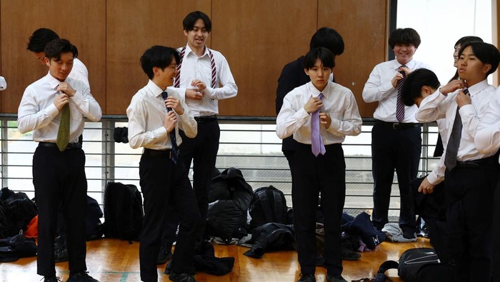 Members of Cheer Re-Man's, an all-male cheer-leading team of active businessmen, perform at 