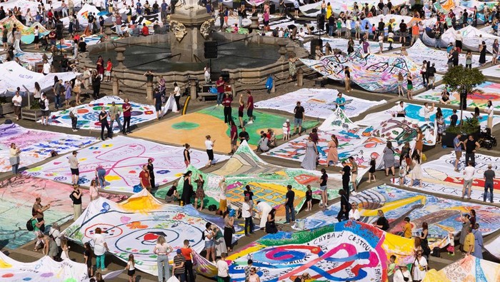 The square of Premysl Otakar II is covered by a giant painting, prepared by people from various city associations, communities, schools, institutions and organisations, which was created by composing 92 canvases of eight by eight metres, in Ceske Budejovice, Czech Republic, June 6, 2025. The event is part of the cultural festivities of SOUTOK - celebration of the 760th anniversary of the city of Ceske Budejovice. REUTERS/Eva Korinkova