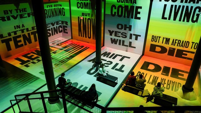 Guests take a picture during Rolling Stone presents: AMPLIFIED exhibition at ARTECHOUSE in New York City, U.S. May 29, 2025. REUTERS/Jeenah Moon.