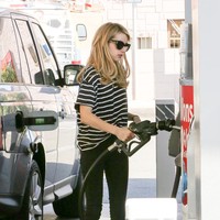 Kaus longgar dan slim jeans menjadi andalan Emma Roberts saat dalam sebuah kesempatan mampir ke pompa bensin untuk mengisi bensin mobil Range Rover yang disetirinya. (Foto: Bauer-Griffin/GC Images)