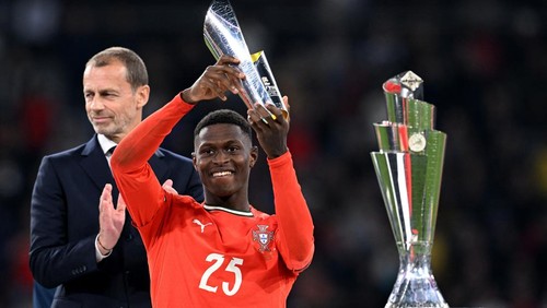 Soccer Football - Nations League - Final - Portugal v Spain - Allianz Arena, Munich, Germany - June 8, 2025 Portugals Nuno Mendes celebrates with a trophy after winning player of the tournament REUTERS/Angelika Warmuth