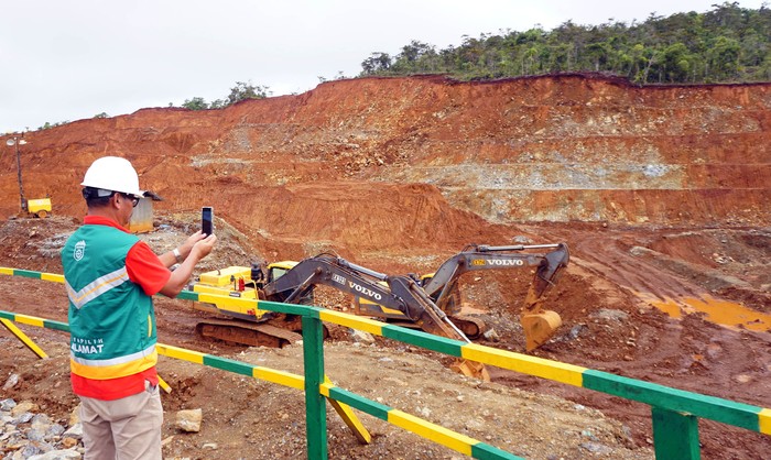 Direksi PT Gag Nikel, Aji Priyo Anggoro mengambil gambar di lokasi terbuka penambangan yang sementara berhenti beroperasi di Pulau Gag Distrik Waigeo Barat Kepulauan Kabupaten Raja Ampat, Papua Barat Daya, Minggu (8/6/2025). PT Gag Nikel memastikan bahwa operasional pertambangan dijalankan sesuai prinsip pertambangan berkelanjutan dan kaidah lingkungan hidup yang berlaku dengan melakukan upaya reklamasi pasca penambangan serta pengolahan limbah yang telah melalui uji baku mutu sehingga tidak menimbulkan dampak ekologis. ANTARA FOTO/Olha Mulalinda/YU