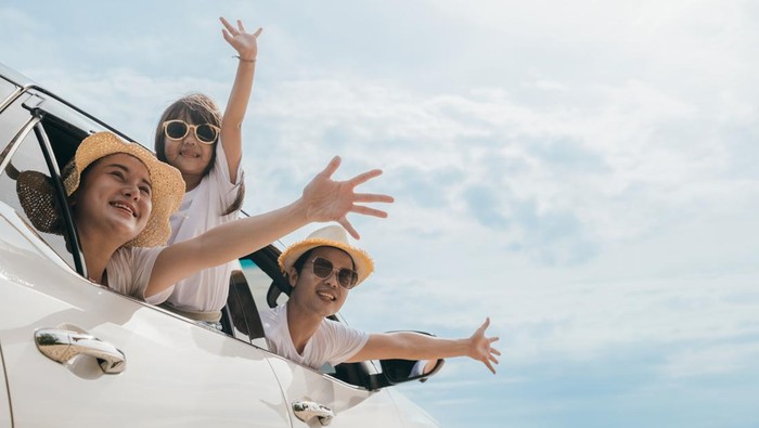 Happy family day. Asian mother father and children smiling sitting in compact white car looking out windows, Summer at the beach, Car insurance, Family holiday vacation travel, road trip concept