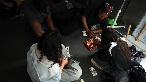 Emily Raad, 28, from east London, reacts while playing chess at Knight Club, a diverse chess club growing to almost a thousand members within a year, based at Fleet Studios, in London, Britain, June 3, 2025. REUTERS/Isabel Infantes