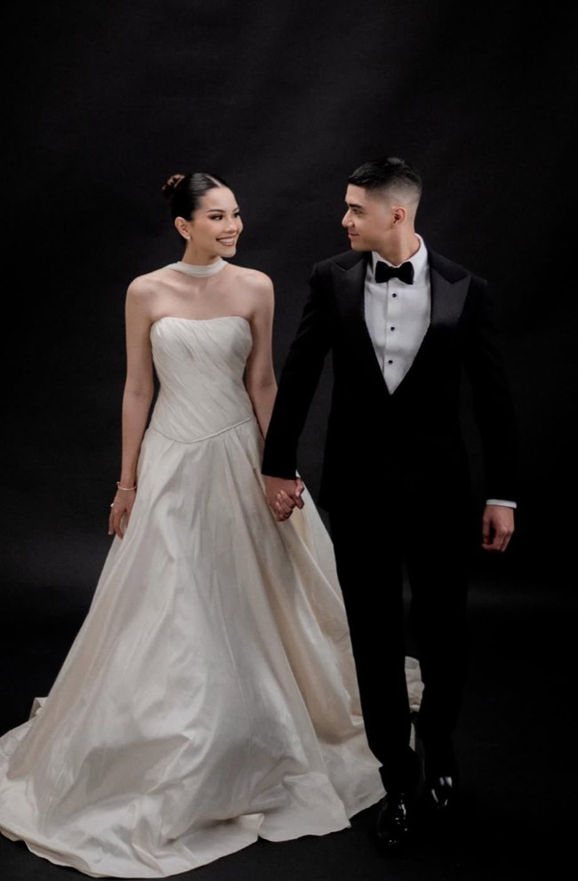 Alyssa tampil anggun dan cantik dengan gaun strapless berwarna putih gading. Berpotongan bustier, gaun tersebut membentuk tubuh bagian atas. Aksen berupa kain panjang yang tergantung dari bagian lehernya hingga ke lantai memberikan kesan anggun dan klasik. Foto: Instagram/@alyssaguise