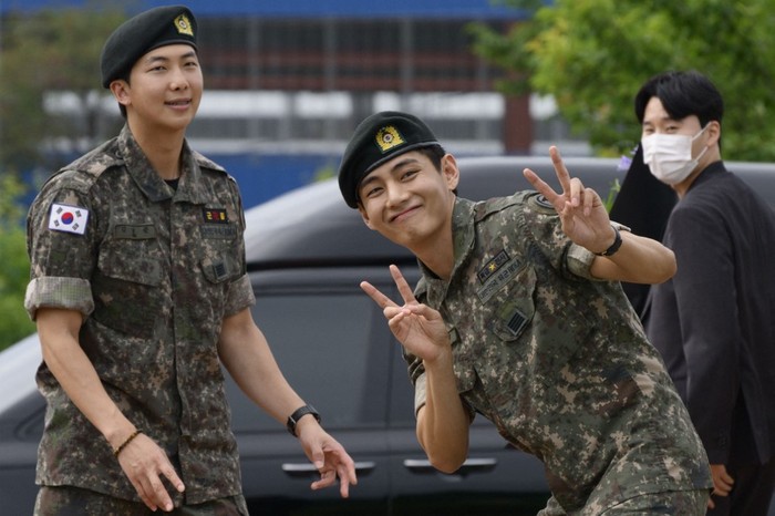 K-pop boy band BTS members RM (L) and V gesture at an outdoor sporting facility in Chuncheon on June 10, 2025, after their release from 18 months of South Korean military service. Hundreds of fans gathered near two army bases just outside of the capital Seoul where band leader RM -- recently named 