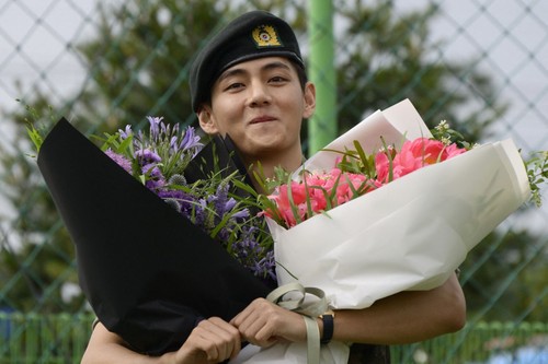 K-pop boy band BTS members RM (L) and V salute at an outdoor sporting facility in Chuncheon on June 10, 2025, after their release from 18 months of South Korean military service. Hundreds of fans gathered near two army bases just outside of the capital Seoul where band leader RM -- recently named 