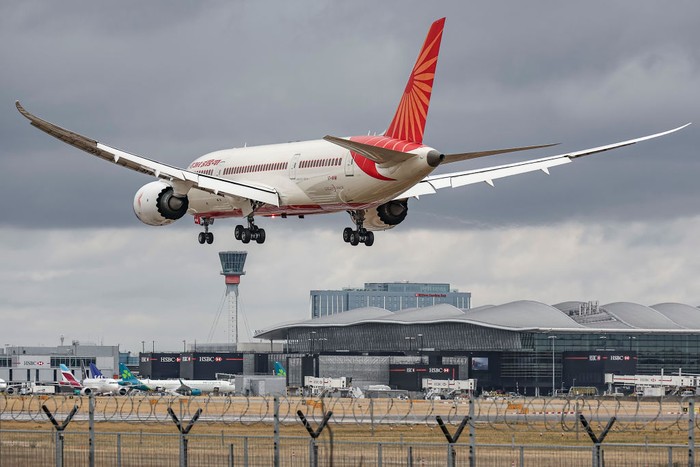 Air India Boeing 787 Dreamliner aircraft as seen on final approach flying for landing at the runway of London Heathrow airport during a cloudy day over Myrtle Avenue, a famous planespotting location. Heathrow Airport Terminal building, the gates, jet bridges, airplanes, the control tower and Hilton Garden Inn Hotel are visible in the background. The modern and advanced Boeing 787-8 wide body passenger plane has the registration VT-ANW and is powered by 2x GE jet engines. Air India is the Indian flag carrier with headquarters at New Delhi and member of Star Alliance aviation group. Air India is owned by Tata Group, formerly AirIndia Limited was owned by the Government of India. London Heathrow Airport LHR, United Kingdom on August 2022 (Photo by Nicolas Economou/NurPhoto via Getty Images)