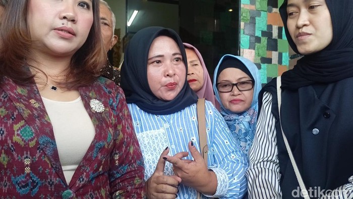 Istri almarhum Kapolsek Negara Batin AKP Anumerta Lusiyanto, Sasnia (baju biru)
