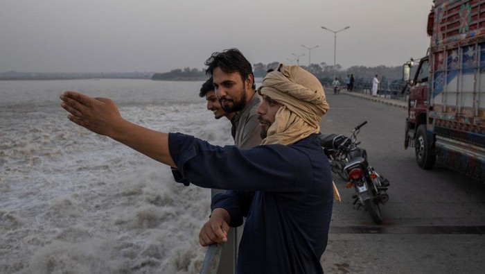 Panas Terik Bikin Warga Pakistan Cari Udara Segar di Pinggir Sungai Warga Sialkot berbondong ke Head Marala, Sungai Chenab, untuk menyegarkan diri. Cuaca ekstrem mendorong keluarga mencari angin segar dari aliran sungai.