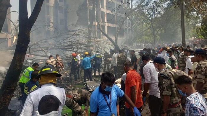 Emergency personnel and other people gather near damaged property, at the site where an Air India plane crashed, in Ahmedabad, India, June 12, 2025. CENTRAL INDUSTRIAL SECURITY FORCE VIA X/Handout via REUTERS    THIS IMAGE HAS BEEN SUPPLIED BY A THIRD PARTY. MANDATORY CREDIT. NO RESALES. NO ARCHIVES.
