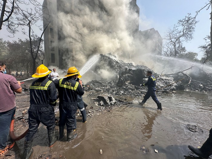 Wreckage of a Boeing 787 Dreamliner lies at the site, showing part of its registration 