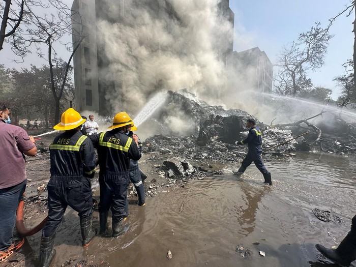 Wreckage of a Boeing 787 Dreamliner lies at the site, showing part of its registration 