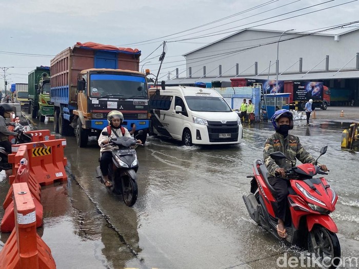 Suasana Jalan Pantura Semarang-Demak, Kecamatan Sayung, Kabupaten Demak, yang tergenang rob sejak dua minggu lalu, Jumat (13/6/2025).