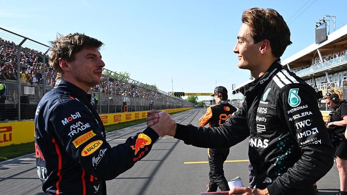 MONTREAL, QUEBEC - JUNE 14: Pole position qualifier George Russell of Great Britain and Mercedes AMG Petronas F1 Team and Second placed qualifier Max Verstappen of the Netherlands and Oracle Red Bull Racing shake hands in parc ferme during qualifying ahead of the F1 Grand Prix of Canada at Circuit Gilles-Villeneuve on June 14, 2025 in Montreal, Quebec. (Photo by Mark Sutton - Formula 1/Formula 1 via Getty Images)