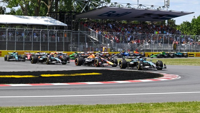 Jun 15, 2025; Montreal, Quebec, Canada; Mercedes driver George Russell (63) exits the starting grid in the lead over Red Bull Racing driver Max Verstappen (1) during the F1 Canadian Grand Prix at Circuit Gilles-Villeneuve. Mandatory Credit: David Kirouac-Imagn Images