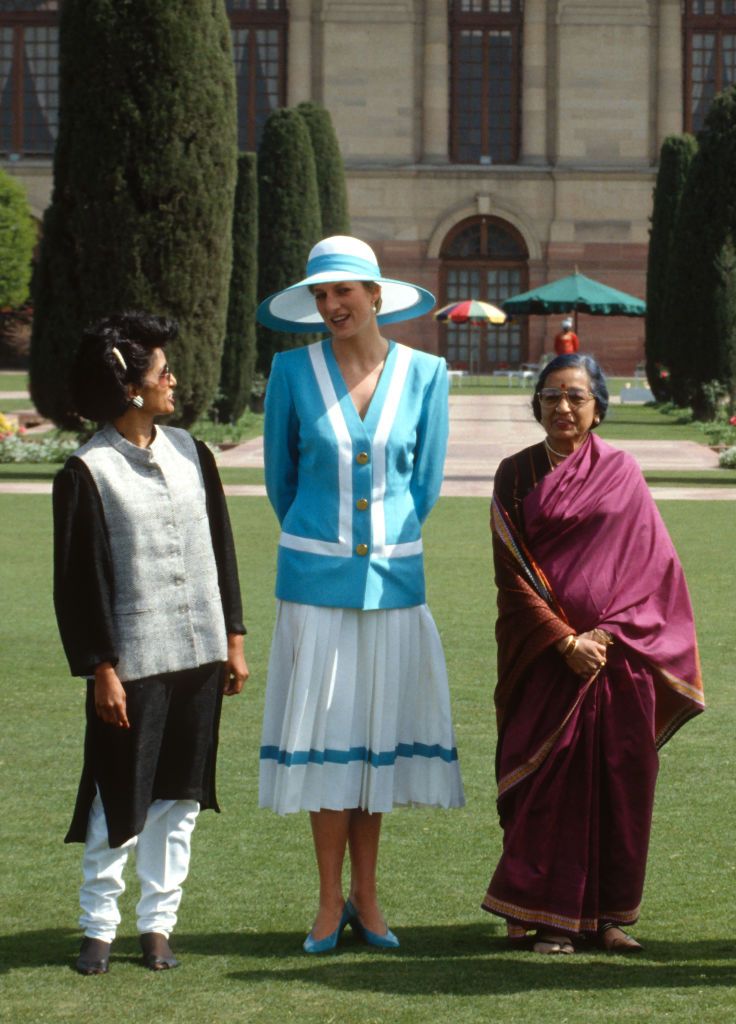 DELHI, INDIA - FEBRUARY 12: Diana, Princess of Wales (C), wearing a blue and white suit designed by Catherine Walker and a Philip Somerville hat, and wife of Indian President Ramaswamy Venkatarama, Janaki Venkataraman (R), stand outside Rashtrapati Bhavan, the presidential palace in New Delhi on February 12, 1992 in Delhi, India. (Photo by Anwar Hussein/Getty Images)