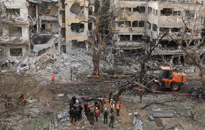 Emergency personnel work at an impact site after missiles were launched from Iran to Israel, in Tel Aviv, Israel, June 16, 2025. REUTERS/Ronen Zvulun