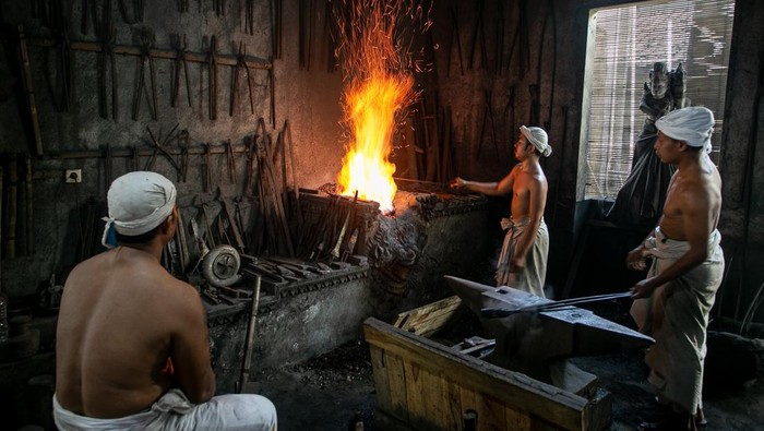 Mengintip Proses Pembuatan Keris Pusaka Tradisional di Karanganyar Panjak atau pembantu empu menempa batang logam saat proses pembuatan keris pusaka di Padepokan Keris Brojobuwono, Wonosari, Gondangrejo, Karanganyar, Jawa Tengah, Selasa (17/6/2025). Untuk membuat satu keris pusaka tersebut empu dan panjak membutuhkan waktu sekitar dua bulan hingga satu tahun karena dalam prosesnya harus menerapkan teknik tradisional yaitu dengan lelaku atau ritual tertentu untuk memenuhi kriteria keris pusaka tosan aji dan agar keris sesuai dengan kepribadian pemiliknya. ANTARA FOTO/Mohammad Ayudha