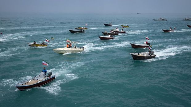 Basij paramilitary force speed boats are sailing along the Persian Gulf during the Islamic Revolutionary Guard Corps (IRGC) marine parade to commemorate Persian Gulf National Day, near the Bushehr nuclear power plant in the seaport city of Bushehr, Bushehr province, in the south of Iran, on April 29, 2024. Persian Gulf National Day, which celebrates the expulsion of the Portuguese from the Strait of Hormuz and the Persian Gulf in 1622 by the Safavid forces led by Imam Quli Khan under the command of Shah Abbas I, is observed on the 10th of Ordibehesht in the Iranian calendar, typically falling in late April or early May. (Photo by Morteza Nikoubazl/NurPhoto via Getty Images)