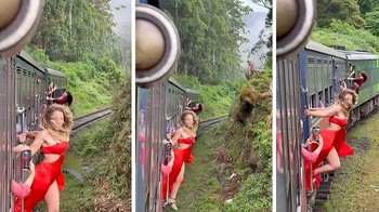 Influencer yang mengenakan gaun merah melakukan aksi berbahaya saat bergelantungan di kereta yang sedang melaju di kawasan hutan demi mendapatkan view di media sosial.Foto: Boredpanda